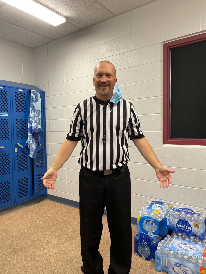 Smith is all smiles as he gets ready to officiate a basketball game.